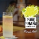 Stilstaand beeld van een glas Pure Pirana hard seltzer op een bar met een citroentje erin. Afkomstig uit de productvideo.